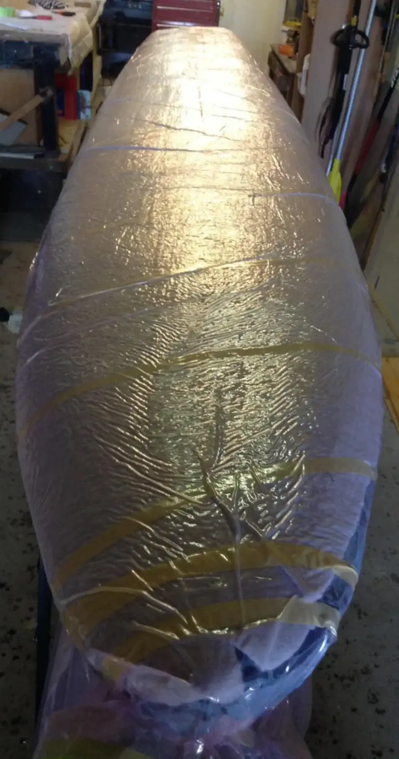 (a) Additional patches of 155\,g/m^2 biaxial weave carbon were used on the deck. (b) Vacuum bagging 200\,g/m^2 plain weave carbon onto the deck.